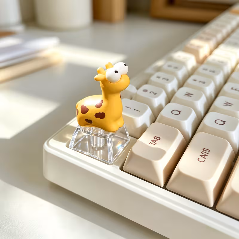 Yellow giraffe resin keycap on a cream mechanical keyboard